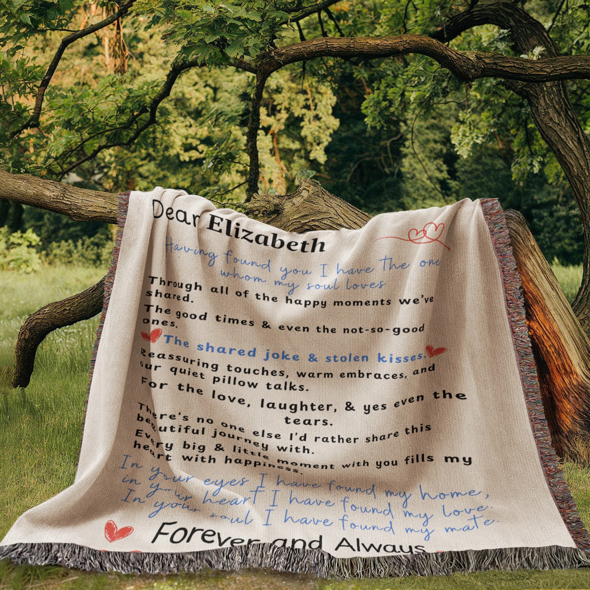 A family heirloom blanket it is a love letter.  A Personalize Gift with custom names laying over a tree limb out side with forest background.