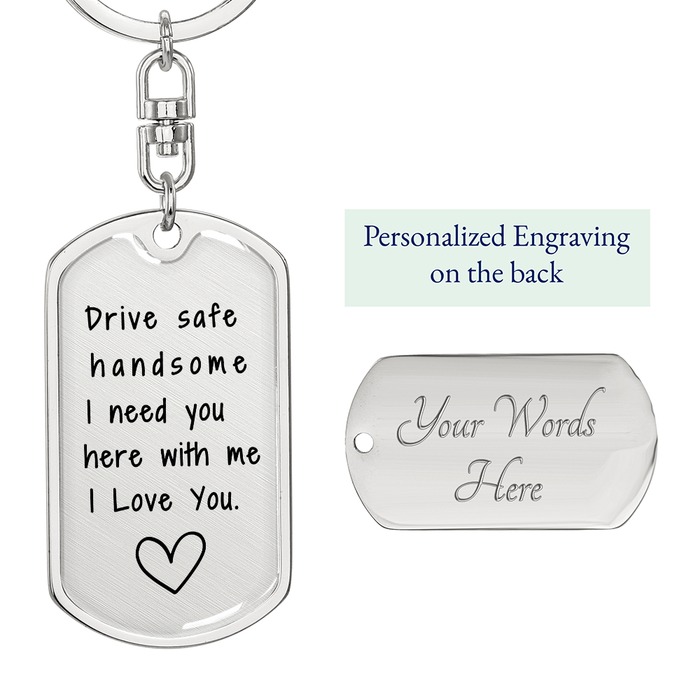 Close-up of silver engraved message on military dog tag keychain, reading 'Drive Safe Handsome, I Need You Here with Me, I Love You' with a heart outline